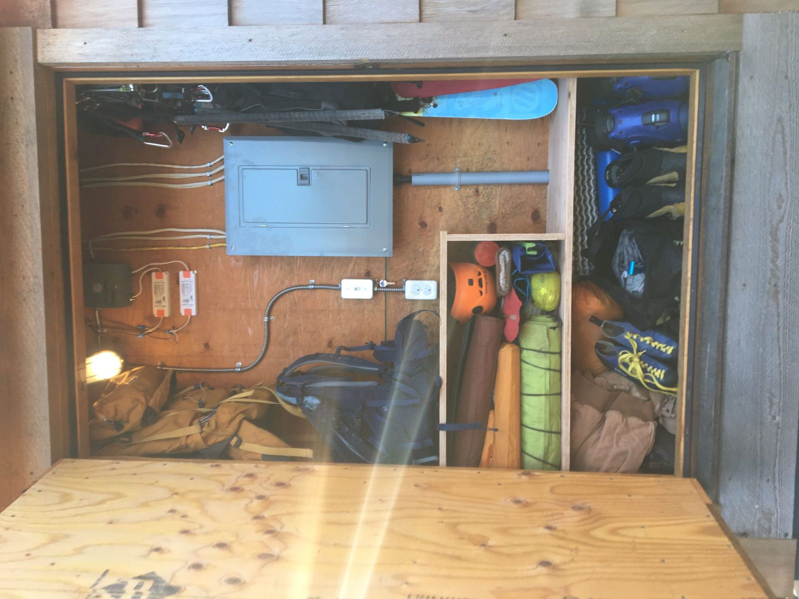 Exterior storage compartment of a tiny home holding gear and the electrical panel on Quadra Island